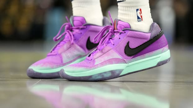 View of purple and black Nike Ja shoes.